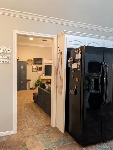a view of a hallway and a livingroom with furniture