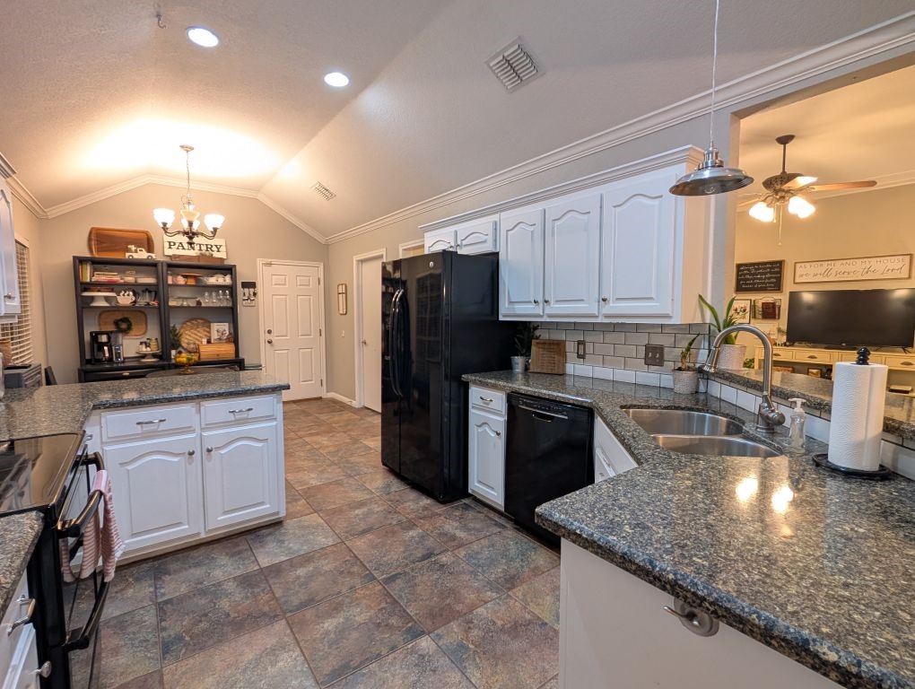 1231 Radisson Drive Hewitt, TX 76643 - Photo 24 of 51 a kitchen with granite countertop a sink a counter top space appliances and cabinets