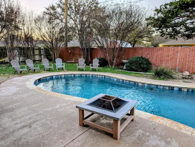a view of a swimming pool with a yard