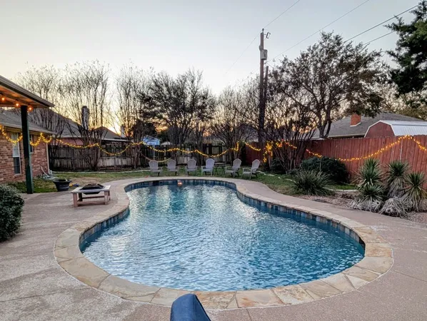 a view of a backyard with sitting area