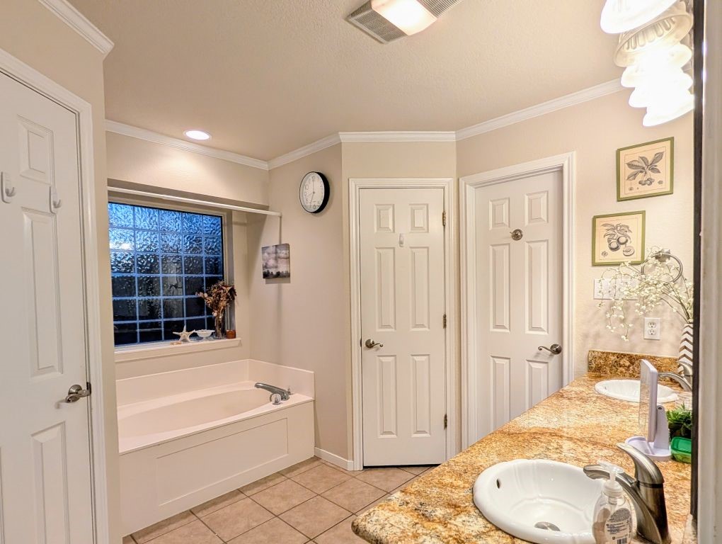 1231 Radisson Drive Hewitt, TX 76643 - Photo 34 of 51 a bathroom with a granite countertop tub sink and mirror