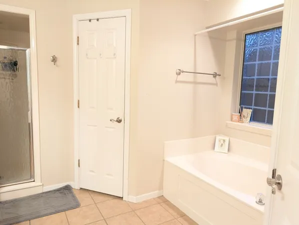a bathroom with a tub and a window