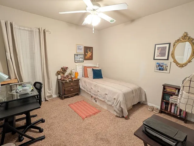 a view of a workspace with furniture and a chandelier