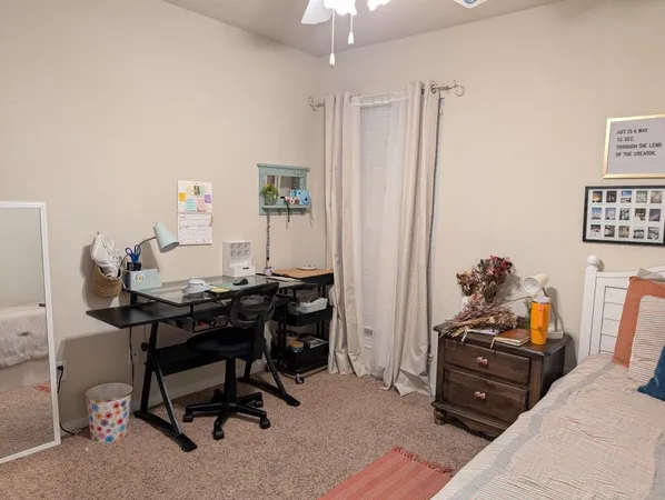 a bedroom with a bed and a chair