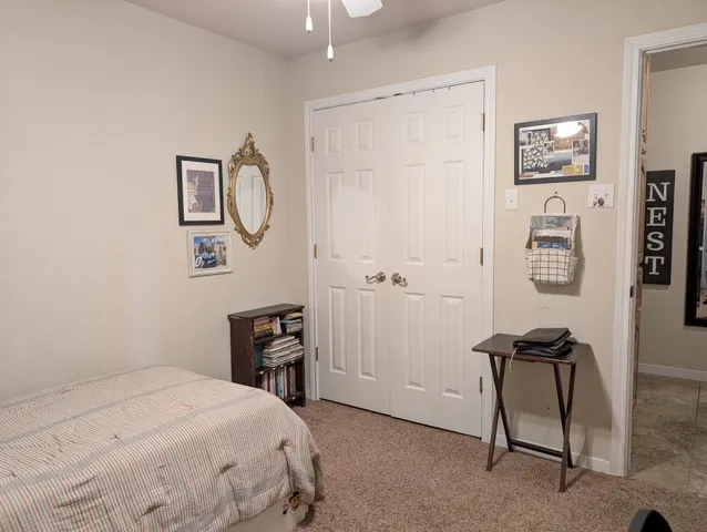 a bedroom with a bed and a chair