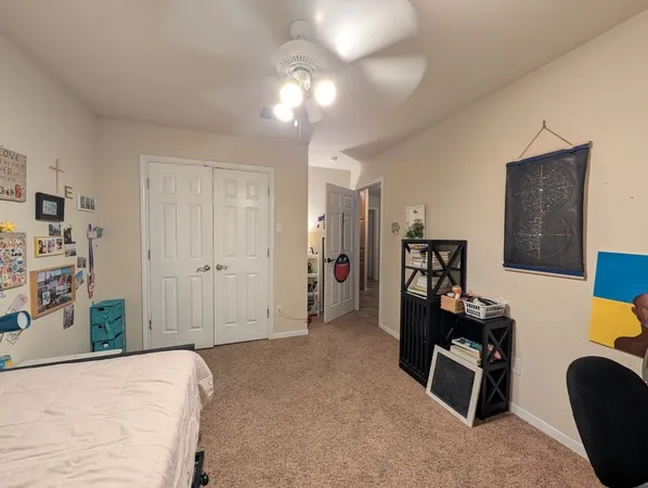 a bathroom with a granite countertop toilet sink and mirror