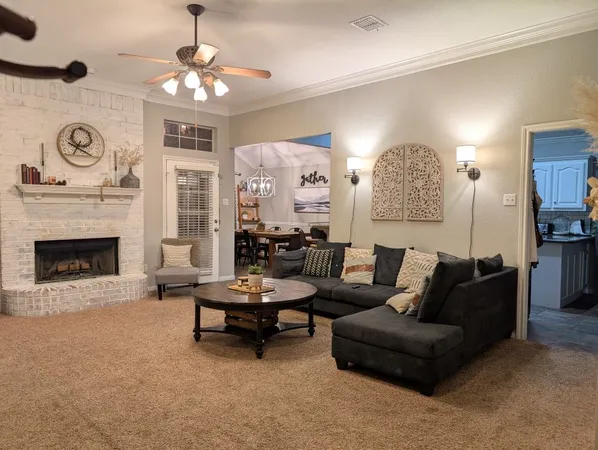 a living room with furniture a fireplace and a window