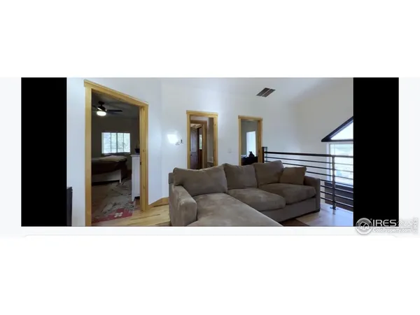 a open living room with a couch and a flat screen tv