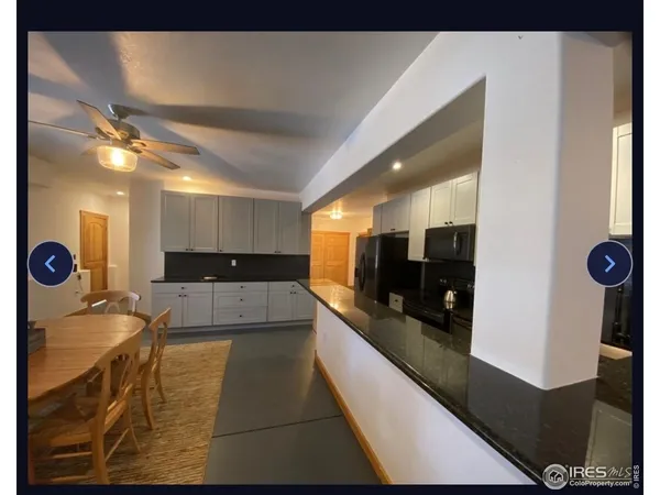 a view of a dining room with furniture and a chandelier