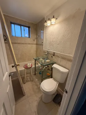 a white toilet sitting next to a bathroom sink