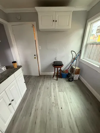 a living room with wooden floor and furniture