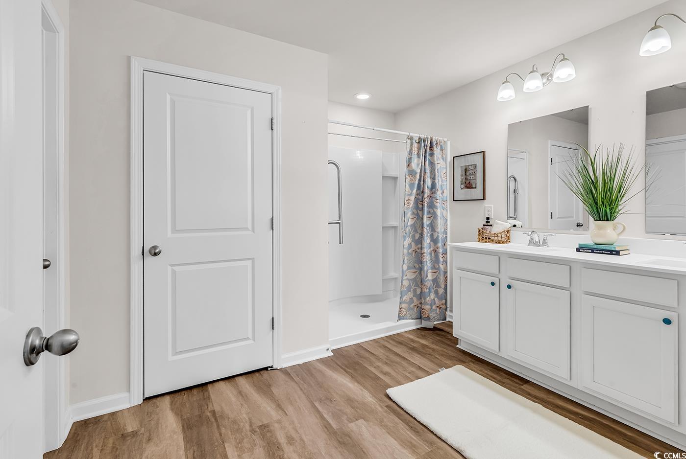 623 Burnt Ash Drive Longs, SC 29568 - Photo 12 of 35 Bathroom with a shower with shower curtain, double vanity, light wood finished floors, and recessed lighting
