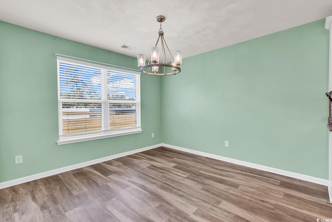 623 Burnt Ash Drive Longs, SC 29568 - Photo 19 of 35 Kitchen with a chandelier, a ceiling fan, a breakfast bar area, dark stone countertops, and recessed lighting