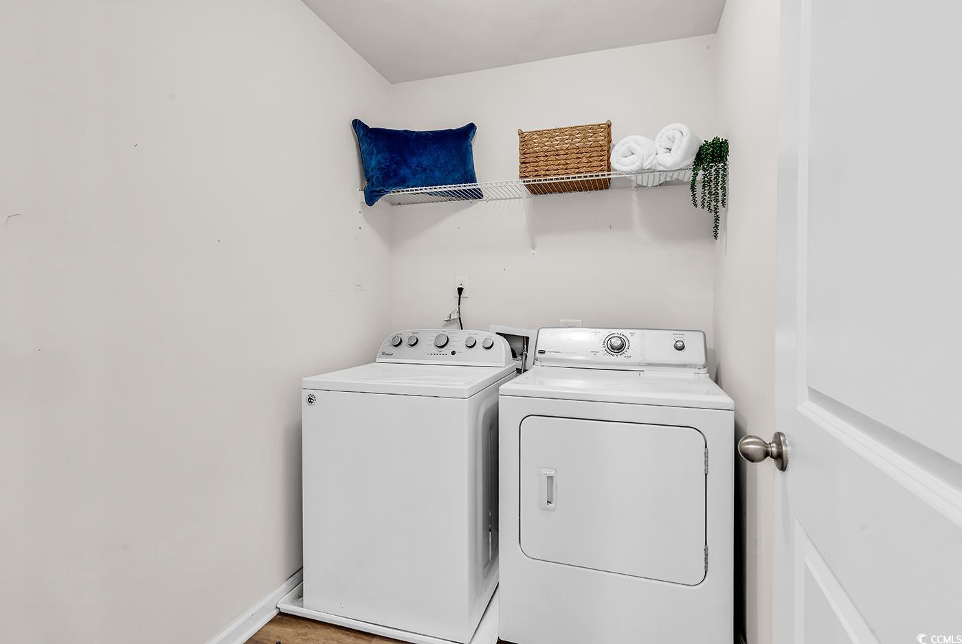 623 Burnt Ash Drive Longs, SC 29568 - Photo 20 of 35 Empty room with wood finished floors and a chandelier