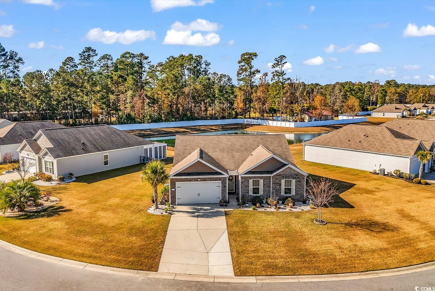 623 Burnt Ash Drive Longs, SC 29568 - Photo 2 of 35 View of front facade with concrete driveway, a front lawn, and stone siding