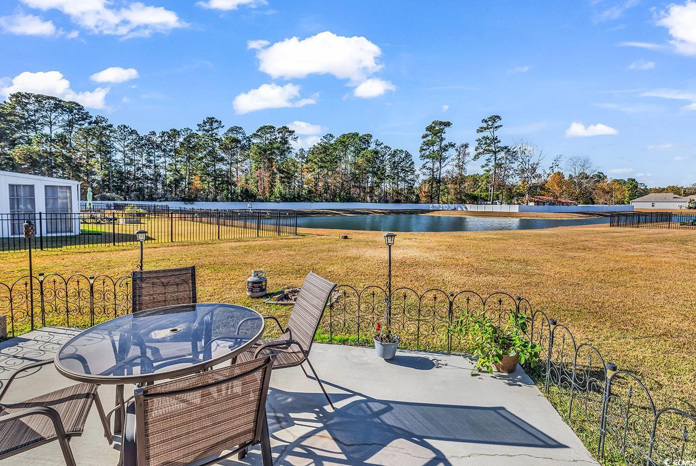 623 Burnt Ash Drive Longs, SC 29568 - Photo 23 of 35 View of patio / terrace with a water view, a sunroom, outdoor dining space, and a ceiling fan