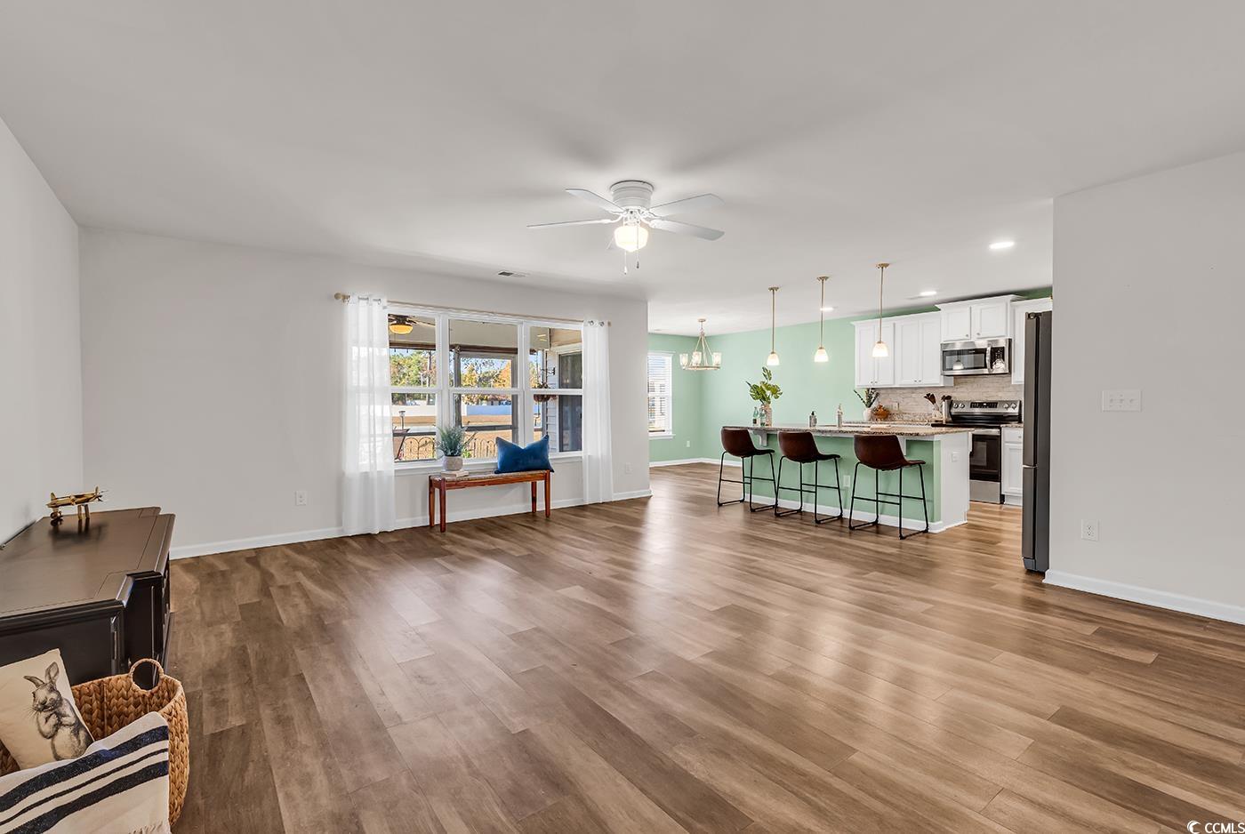 623 Burnt Ash Drive Longs, SC 29568 - Photo 3 of 35 Living area with dark wood-style floors, a chandelier, a ceiling fan, and recessed lighting
