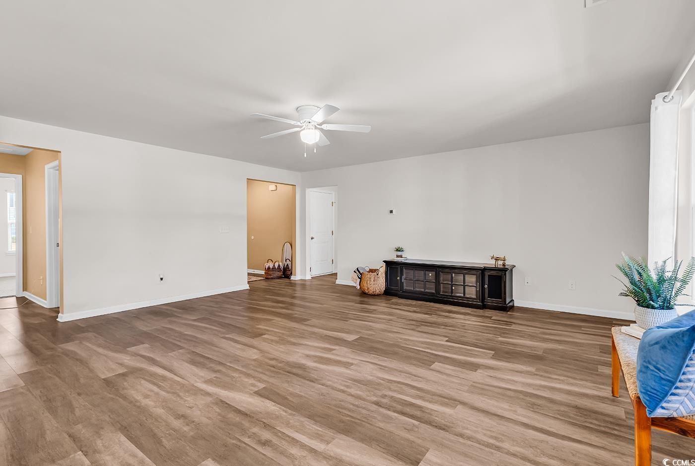 623 Burnt Ash Drive Longs, SC 29568 - Photo 6 of 35 Unfurnished living room featuring light wood-type flooring and a ceiling fan