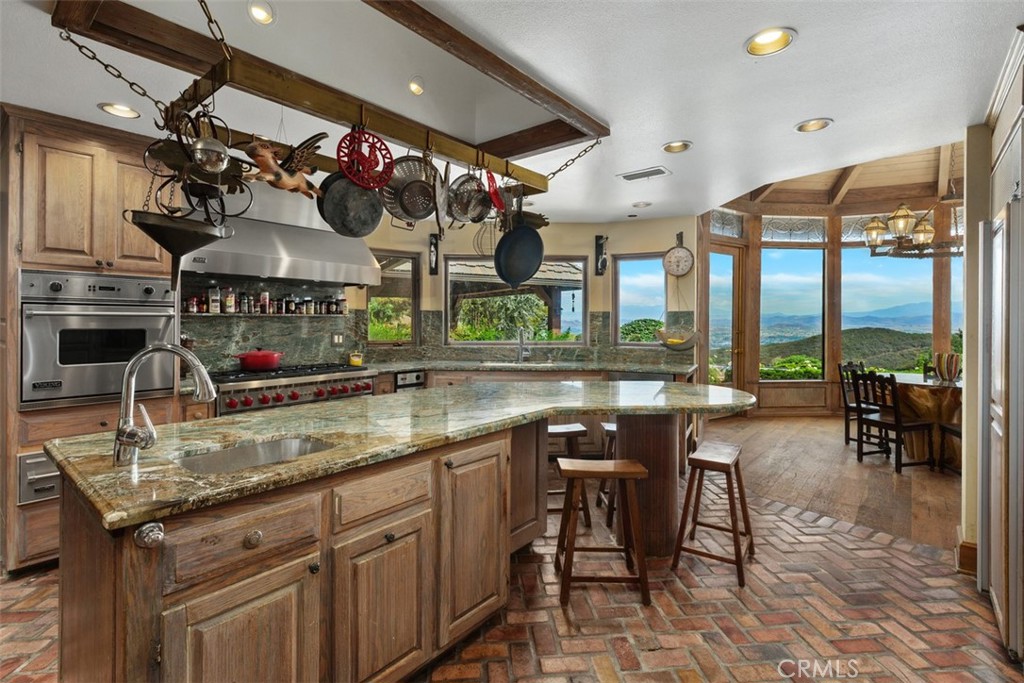 27777 Sycamore Mesa Road Temecula, CA 92590 - Photo 22 of 72 Gourmet Chefs Kitchen with granite counter tops, convenient spice shelf above cook range, center island with 2nd sink & dining counter