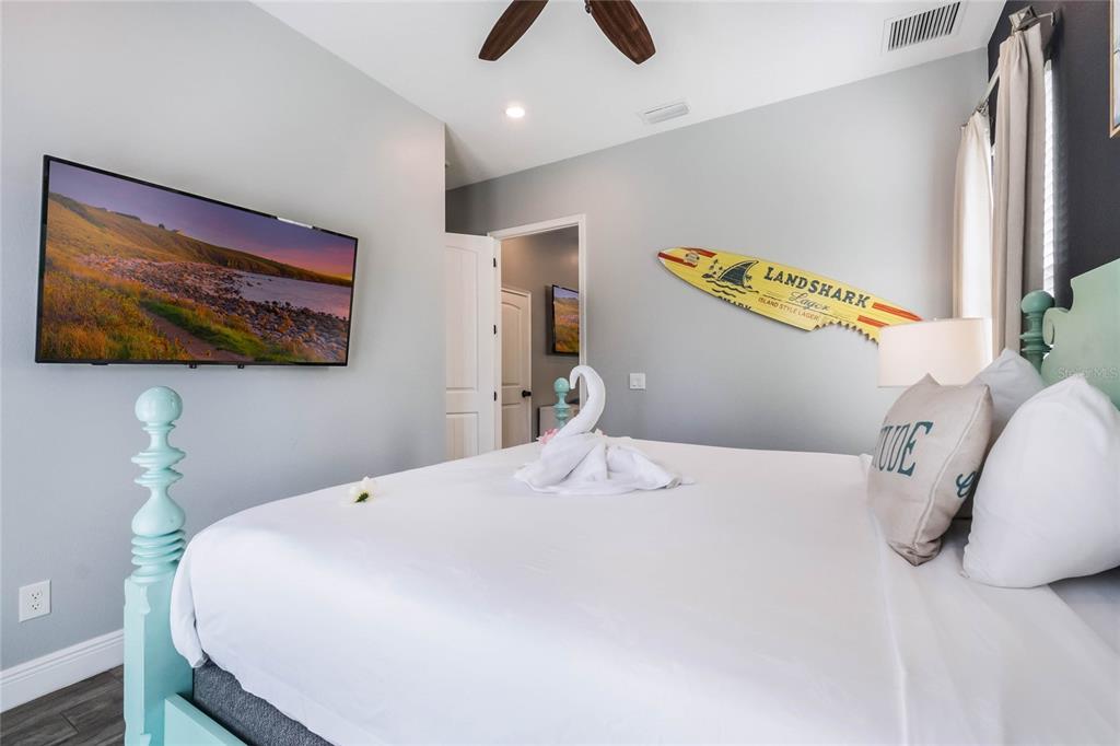 8008 Sandy Toes Way Kissimmee, FL 34747 - Photo 12 of 21 a bedroom with a bed and a flat screen tv