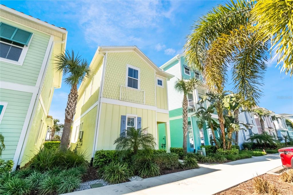 8008 Sandy Toes Way Kissimmee, FL 34747 - Photo 2 of 21 a front view of a multi story residential apartment building with yard and trees