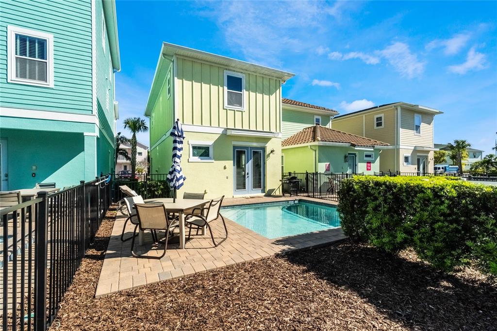 8008 Sandy Toes Way Kissimmee, FL 34747 - Photo 21 of 21 a view of a house with backyard sitting area and garden
