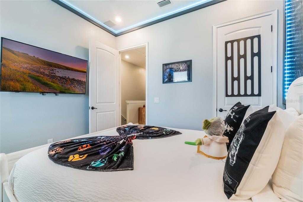 8008 Sandy Toes Way Kissimmee, FL 34747 - Photo 7 of 21 a bedroom with a bed and wooden floor