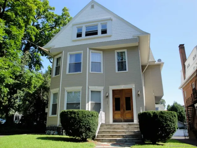 a front view of a house with a yard