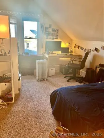 a bedroom with bed and window