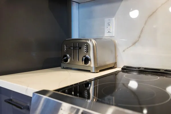 a kitchen with stainless steel appliances granite countertop a stove a sink dishwasher and a refrigerator