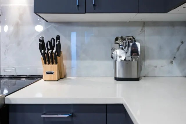 a view of a dining room with furniture and a chandelier fan