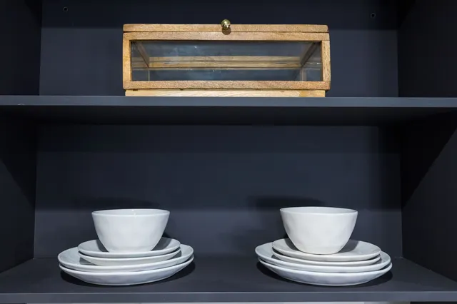 a bedroom with a bed and painting on the wall