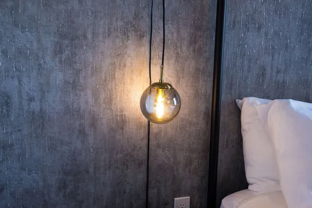 a bedroom with a bed and lamp