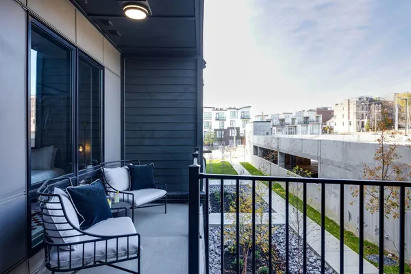 a balcony with an outdoor seating