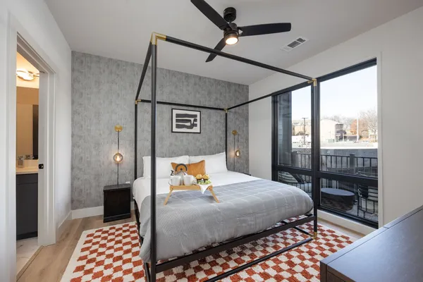 a bedroom with a bed and wooden floor
