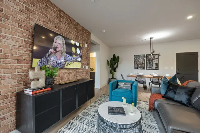 a living room with furniture a rug and a chandelier