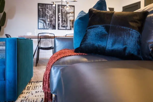 a bed sitting in a bedroom next to a window with wooden floor