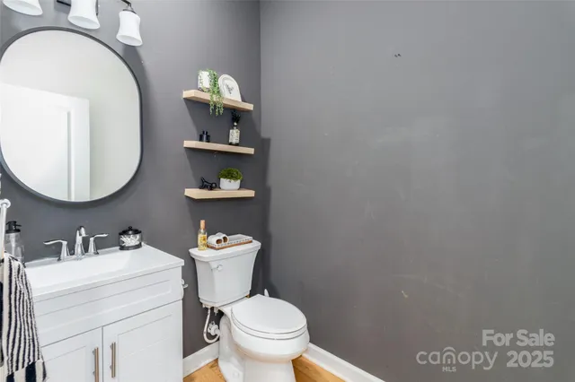 a bathroom with a toilet a sink and mirror