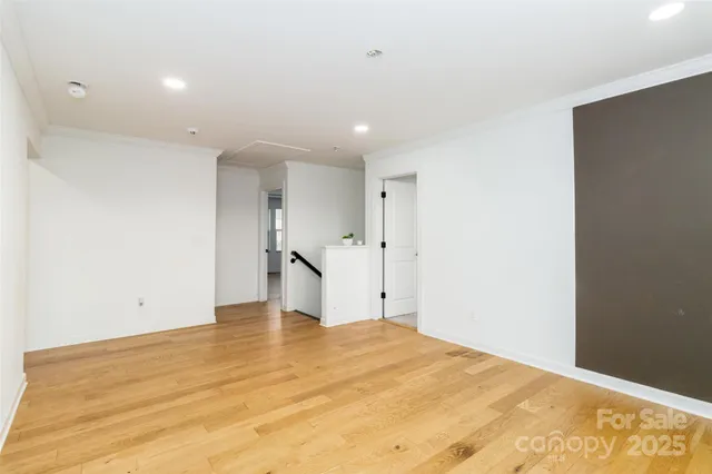 a bedroom with a bed window and walk in closet with a large window