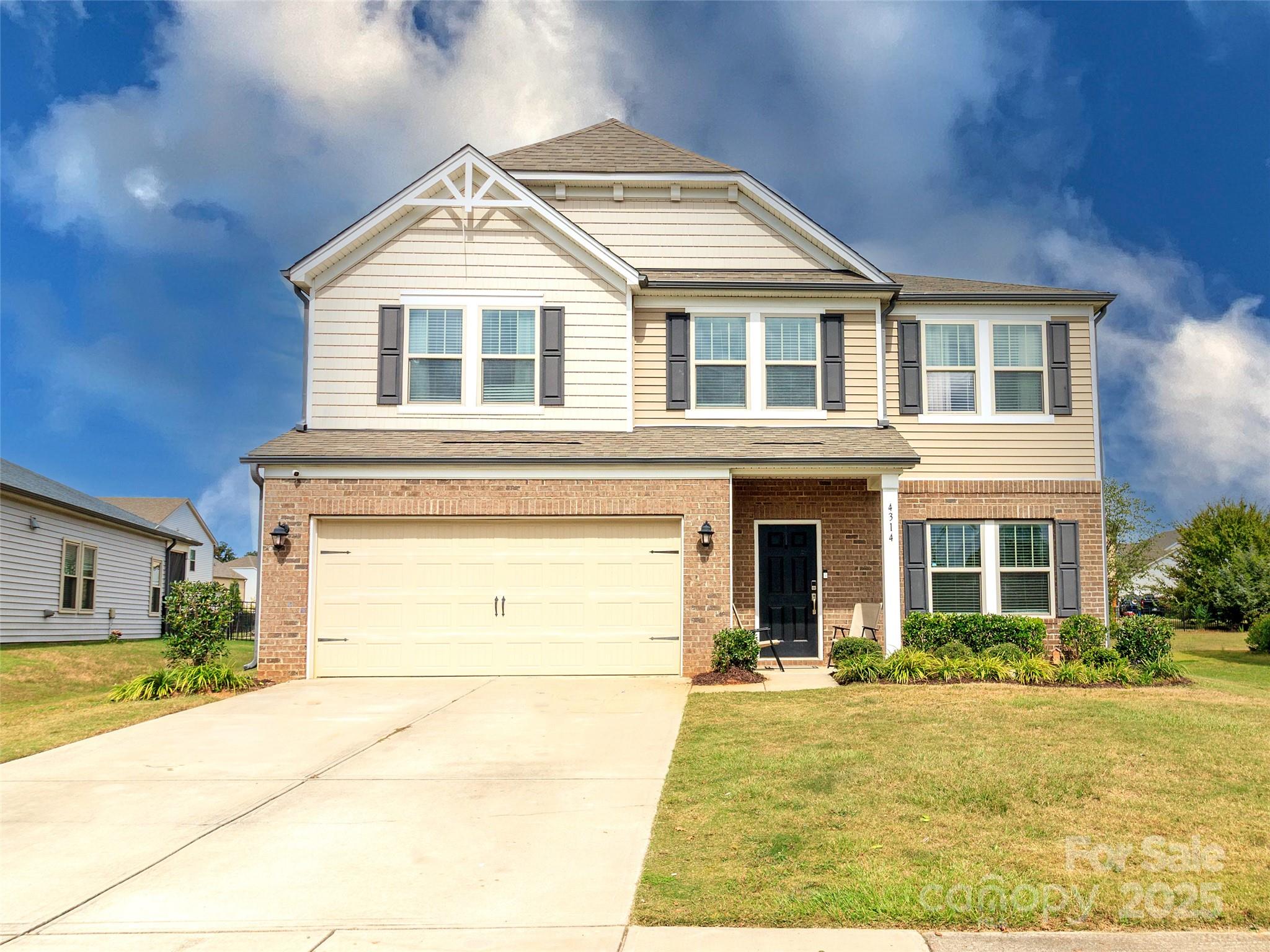 4314 Collingham Drive Charlotte, NC 28273 - Photo 2 of 46 a front view of a house with a yard and garage