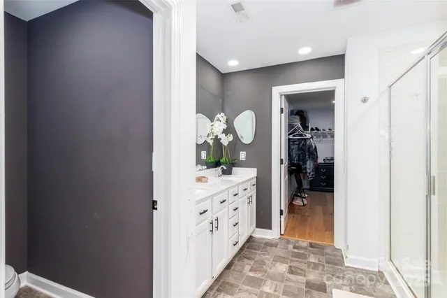 a spacious bathroom with a double vanity sink mirror and double