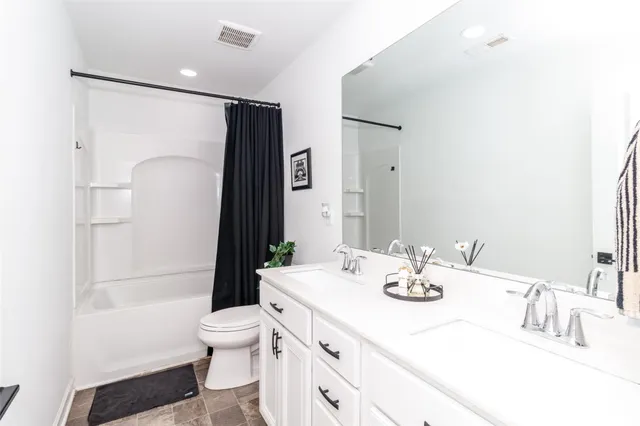 a large bed sitting in a bedroom next to a window