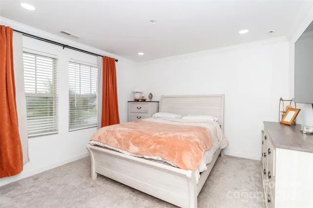 a bedroom with a large bed and a window