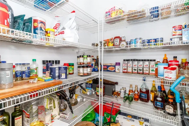 a store room with lots of clutter and stainless steel appliances
