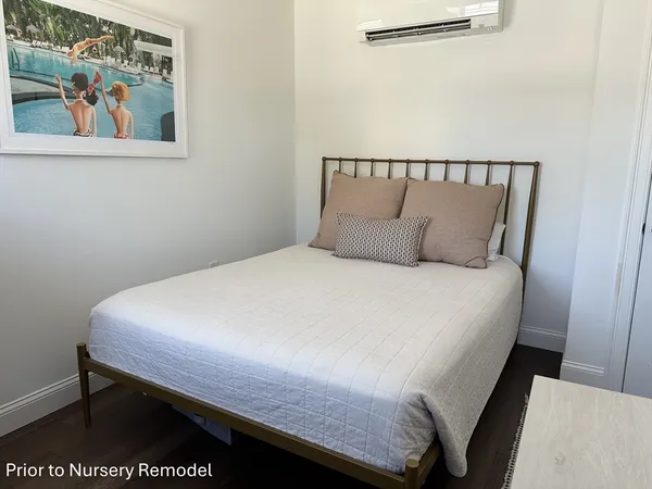 a bed sitting in a bedroom next to a wall