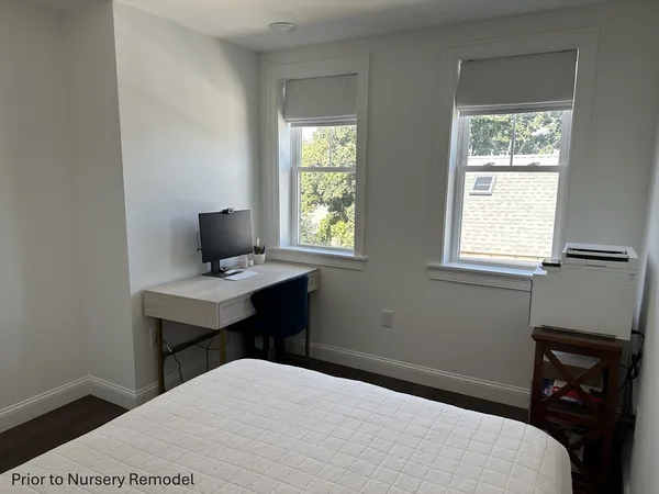 a bedroom with a bed window and table