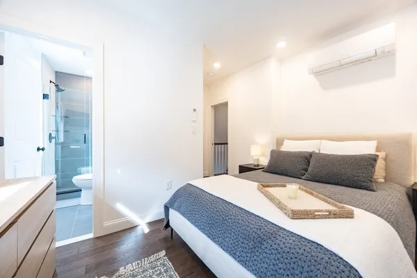 a bedroom with a bed and wooden floor