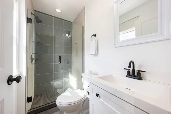 a bathroom with a sink toilet and shower