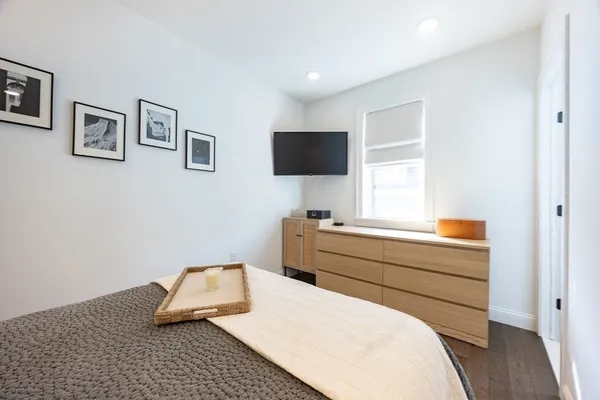 a room with a bed and a flat screen tv