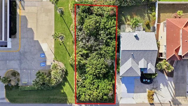 an aerial view of a house with garden space and street view